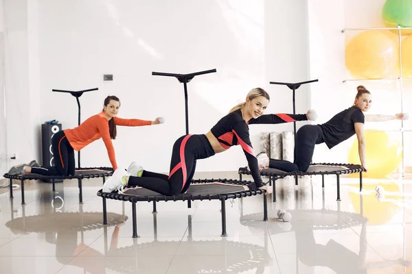 Jumping young women on a trampoline