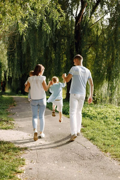 Zadní pohled fotografie rodiny procházející se v letním parku — Stock fotografie