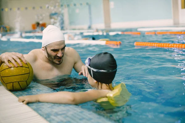Chica aprendiendo a nadar con el entrenador en el centro de ocio —  Fotos de Stock