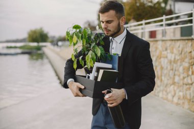 European employee got fired. He drinks alcohol from bottle.