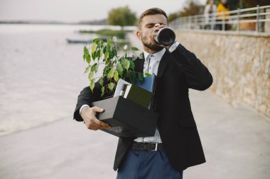 European employee got fired. He drinks alcohol from bottle.