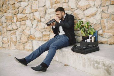 European employee got fired. He drinks alcohol from bottle.