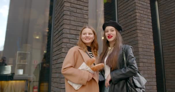 Two Female Friends Standing Building Chatting One Girl Holding Fresh — Stock Video