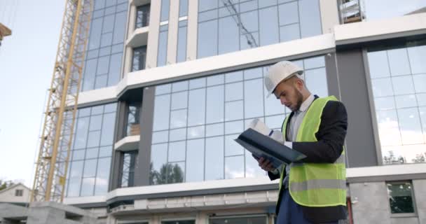 Engineer Hardhat Standing Buiding Putting Notes Checking Building Site — Video Stock