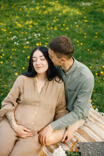 Couple Waiting First Baby Sitting Grass Hugging Pregnant Woman Her — Stockfoto