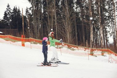 Young and active brunette skiing. Woman in the snowy mountains.