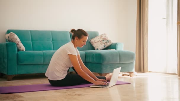 Young adult woman taking online yoga class. — Stok video