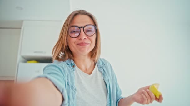 A young cheerful woman wearing glasses recording the video for social media — Stock video