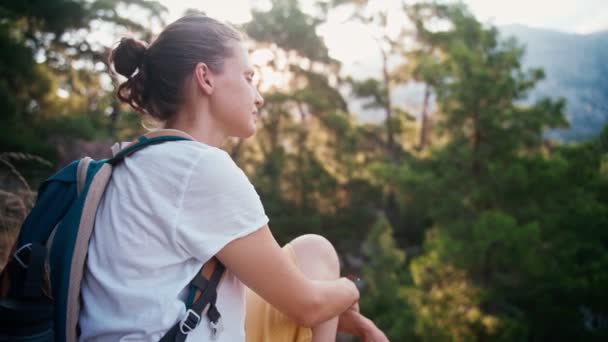 A young adult woman backpacker enjoying the fresh air and the view — Wideo stockowe