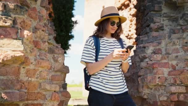 Una Joven Turista Con Sombrero Gafas Sol Usa Teléfono Mientras — Vídeo de stock