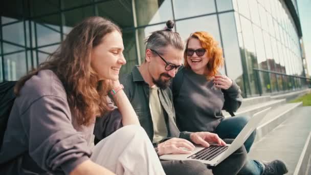 Group Three Young Caucasian Friends Discussing Project Looking Laptop Screen — Stock Video