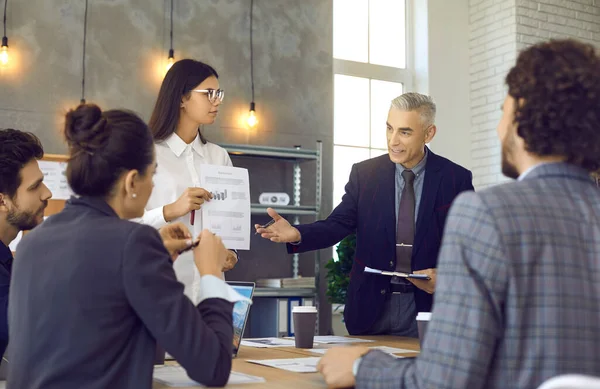 Homme gestionnaire fait une présentation à ses subordonnés, leur parler de nouvelles idées d'affaires. — Photo