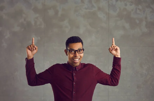 Afro-Amerikaanse man met grappig gezicht houden van twee handen vinger naar boven gericht — Stockfoto