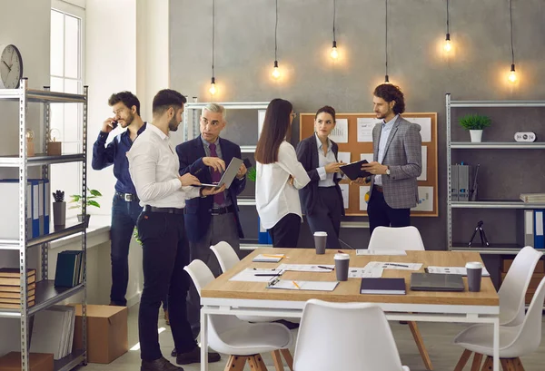 Office colleagues talking at work discussing project strategic plan sharing idea — Foto Stock