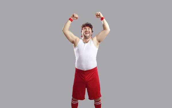 Funny sportsman with raised fist showing power isolated on studio copyspace — Fotografie, imagine de stoc