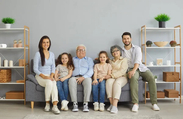 Ritratto di felice famiglia multigenerazionale seduta tutti insieme sul divano di casa — Foto Stock