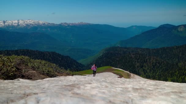 Femme randonneur surmonter pente de montagne enneigée — Video