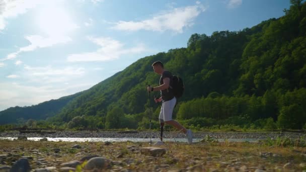 Disabled man with prosthetic leg is travelling alone in nature — Stock Video