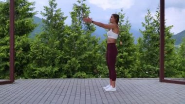 breathing and physical exercise in daily morning workout, woman is training outdoors in park
