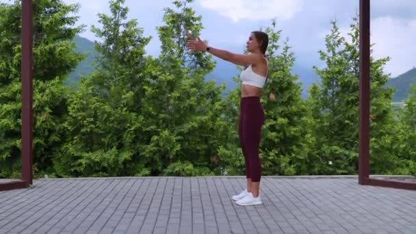 Breathing and physical exercise in daily morning workout, woman is training outdoors in park — Video