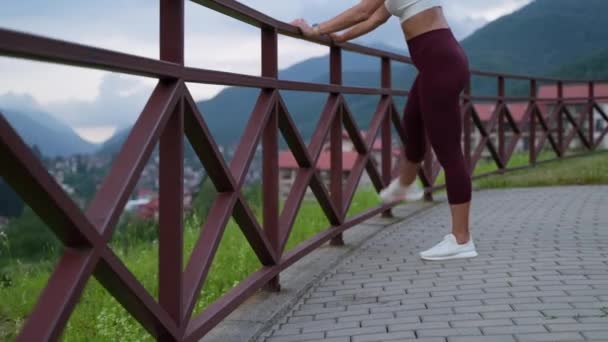 Sportswoman exercising in scenic highland place — стоковое видео