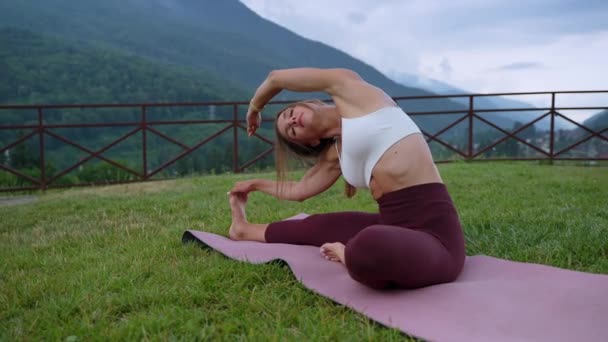Stretching body after training, woman is exercising in nature alone — Videoclip de stoc