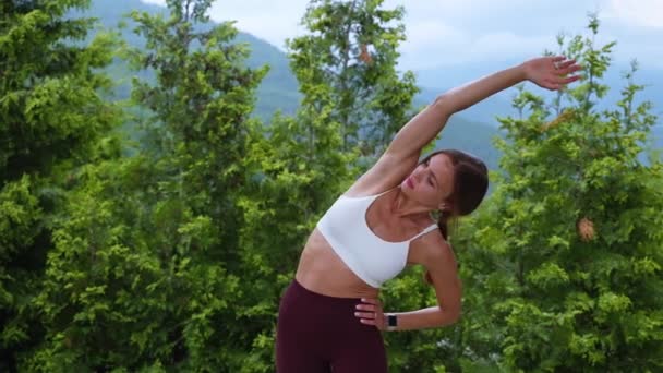 Fit woman warming up with lateral body bends — Stock videók