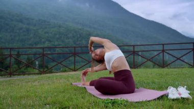 Woman practicing yoga in highlands