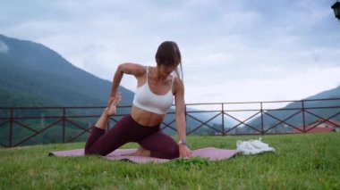 young woman is doing yoga exercises for stretching her body