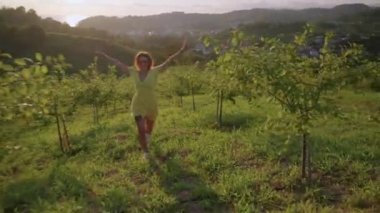 happiness and freedom, woman is running in garden and enjoying good weekend in country