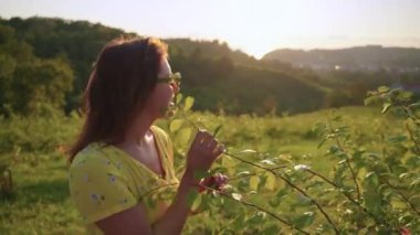 young woman is enjoying by nature in farm garden in highland