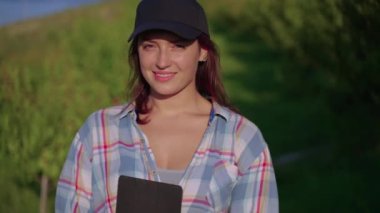 young woman in nature in sunny day, walking in orchard in farm