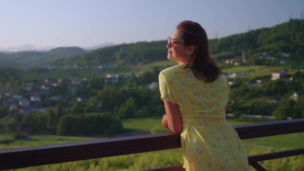 Observation deck in modern eco hotel in mountains, woman is enjoying view in summer — Wideo stockowe