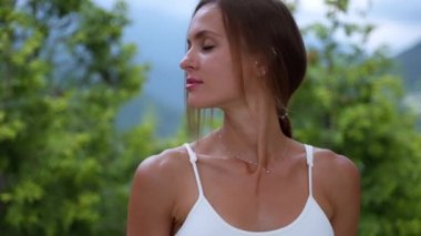 woman is doing morning exercise in park or garden in summer