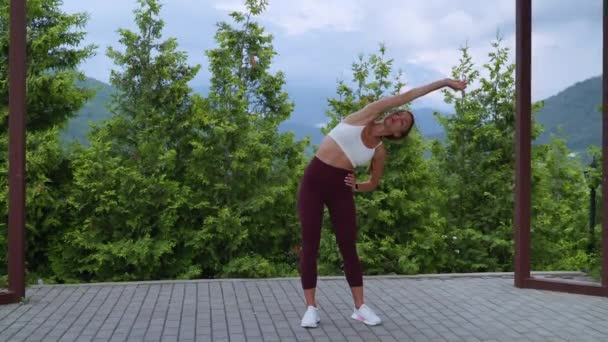 Morning exercises in park in summer, woman is training alone, fitness for keeping fit — Video
