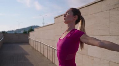 stretching workout in summer morning, young slender woman is doing physical exercise