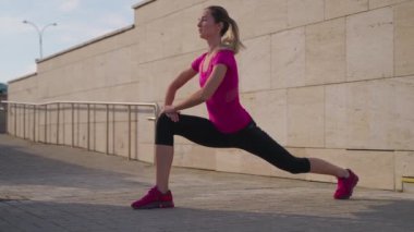 young sporty woman is training in morning, workout in city street and meditation