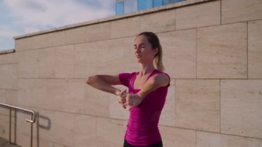 woman is doing physical and breathing exercises outdoors in morning