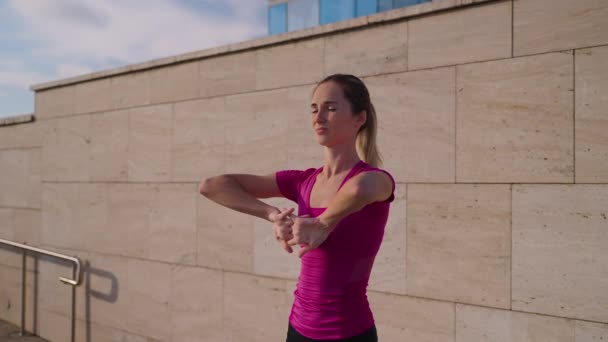 Woman is doing physical and breathing exercises outdoors in morning — 图库视频影像