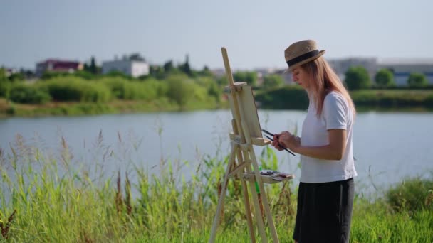 Woman artist painting on easel outdoor — Stock Video