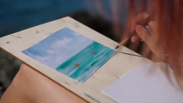 Mujer talentosa está dibujando el paisaje marino de la naturaleza, sentado en la orilla y la pintura por Aquarelle — Vídeo de stock