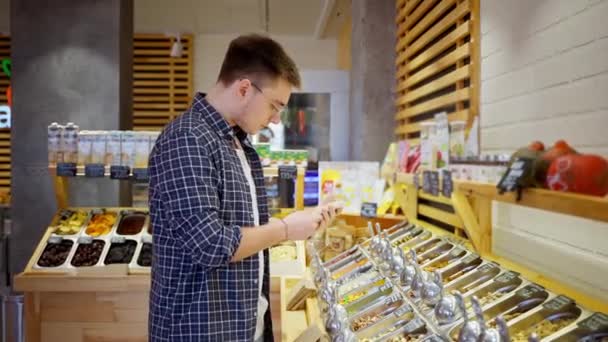 Hombre Revisando Paquete Con Nueces Cedro Pie Junto Pantalla Tienda — Vídeos de Stock