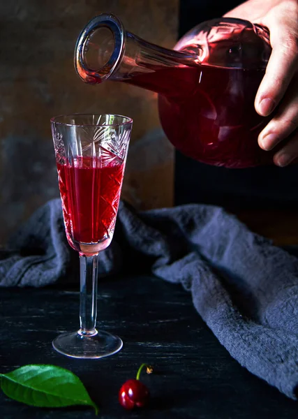 Womans Hand Pours Cherry Liqueur Glass Homemade Cherry Liqueur — Zdjęcie stockowe