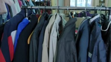 Showcase with a second-hand hanger. Humanitarian aid warehouse.