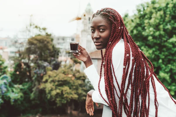 Black Woman Red Braids Balcony Holding Cup Coffee Blurred Trees — Stock Photo, Image