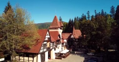 4K Aerial Footage of the Ancient Romanian Castle in the Heart of Awesome Autumn Green Forest, Pelisor