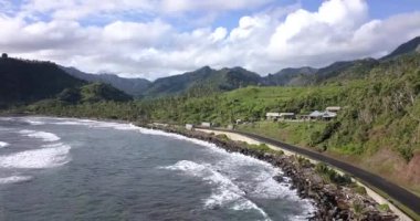 4K Aerial Footage of the Wild coast of Dominica Island and the road with passing cars, Caribbean Sea