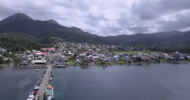 4K Aerial Footage View to the Green and Natural Portsmouth Coastline and Dock of the Dominica Island, Caribbean Sea