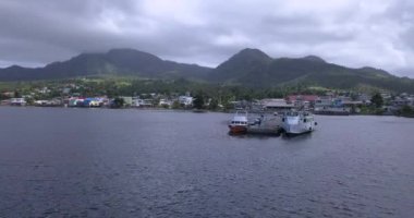 4K Aerial Footage View to the Green and Natural Portsmouth Coastline and Dock of the Dominica Island, Caribbean Sea