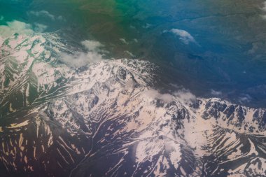 Dubai şehrinin altındaki Parlak ve Renkli Bulutlara Hava Görüntüsü Birleşik Arap Emirlikleri Uçak Penceresinden